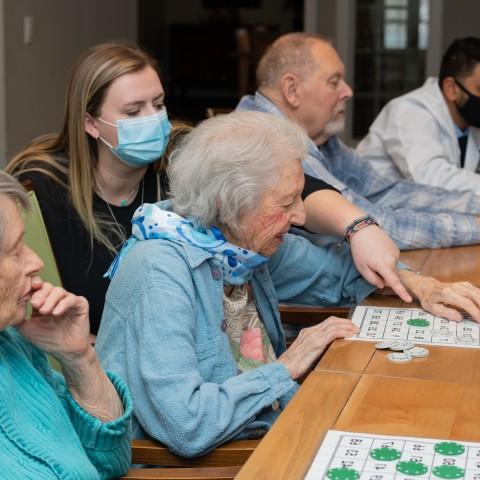 UNE health professions students play bingo with seniors at an assisted living facility